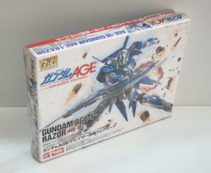Gundam Age-1 Razor Sala 1:144 con LibroGundam Age-FX. Bandai 2012